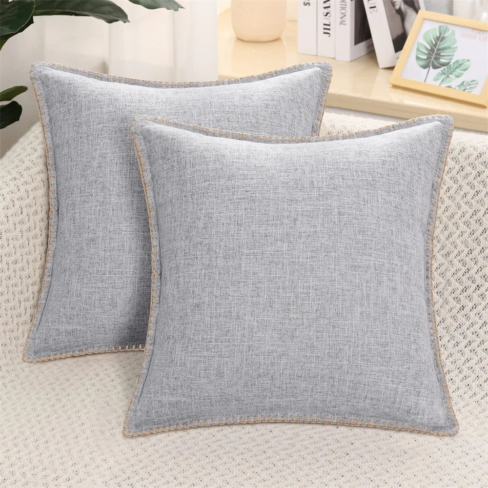 Two light gray velvet cushion covers with a solid pattern and visible texture, displayed on a neutral background.