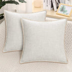 Two light gray velvet cushion covers with a solid pattern and decorative trim, displayed on a neutral background.