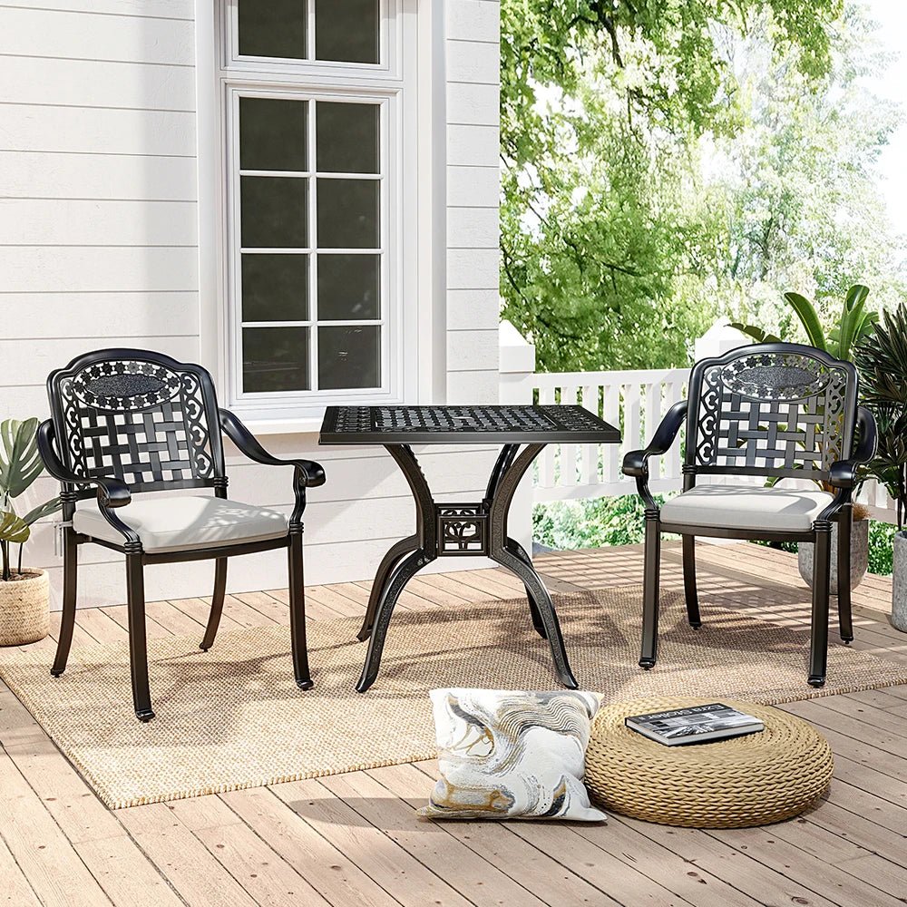 Outdoor patio set with table and chairs on a wooden deck.