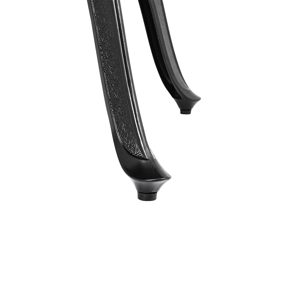 Close-up of a black metal rod with textured surface on a white background