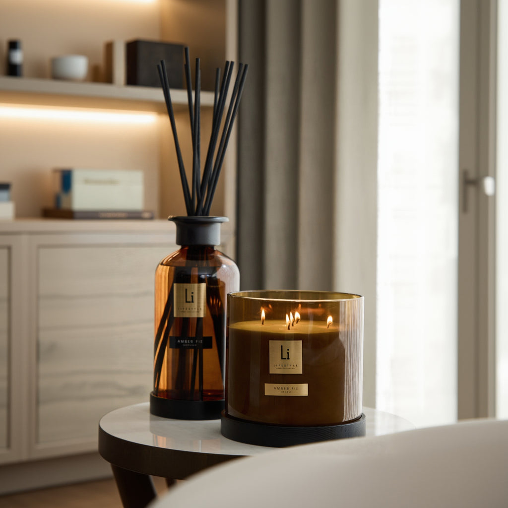 Candle and diffuser set with 'Li' branding on a surface.