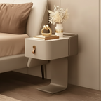 Modern nightstand next to a bed with decorative items