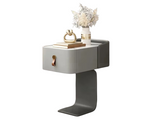 Modern side table with a drawer and decorative items on a white background