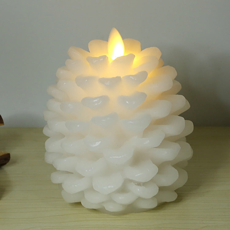 White textured candle with a lit flame on a wooden surface