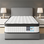 Mattress on a bed frame in a bedroom setting with lamps and nightstands.
