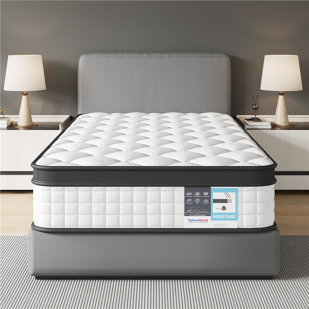 Mattress on a bed frame in a bedroom setting with lamps and nightstands.