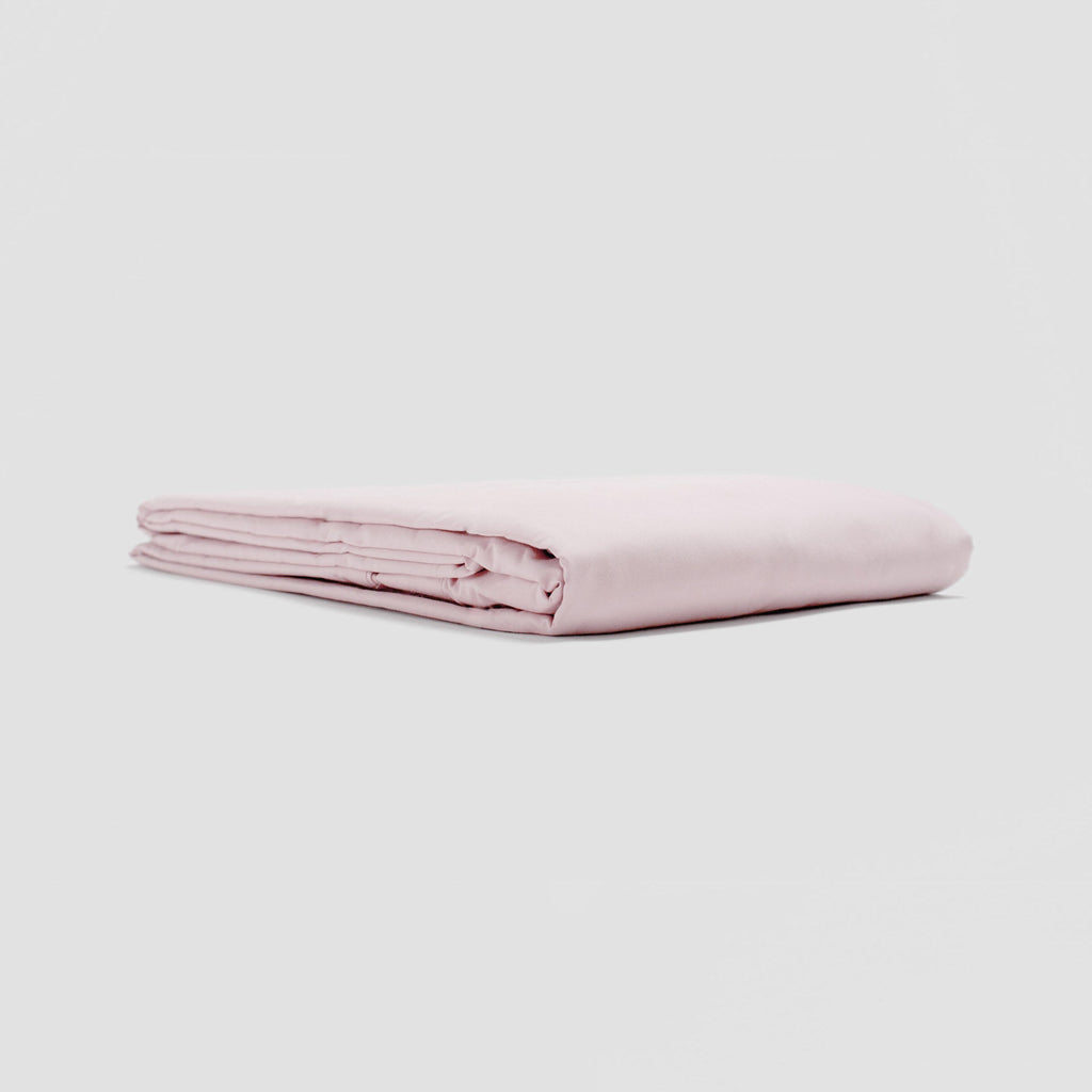 Folded pink fabric on a light gray background