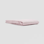 Folded pink fabric on a light gray background