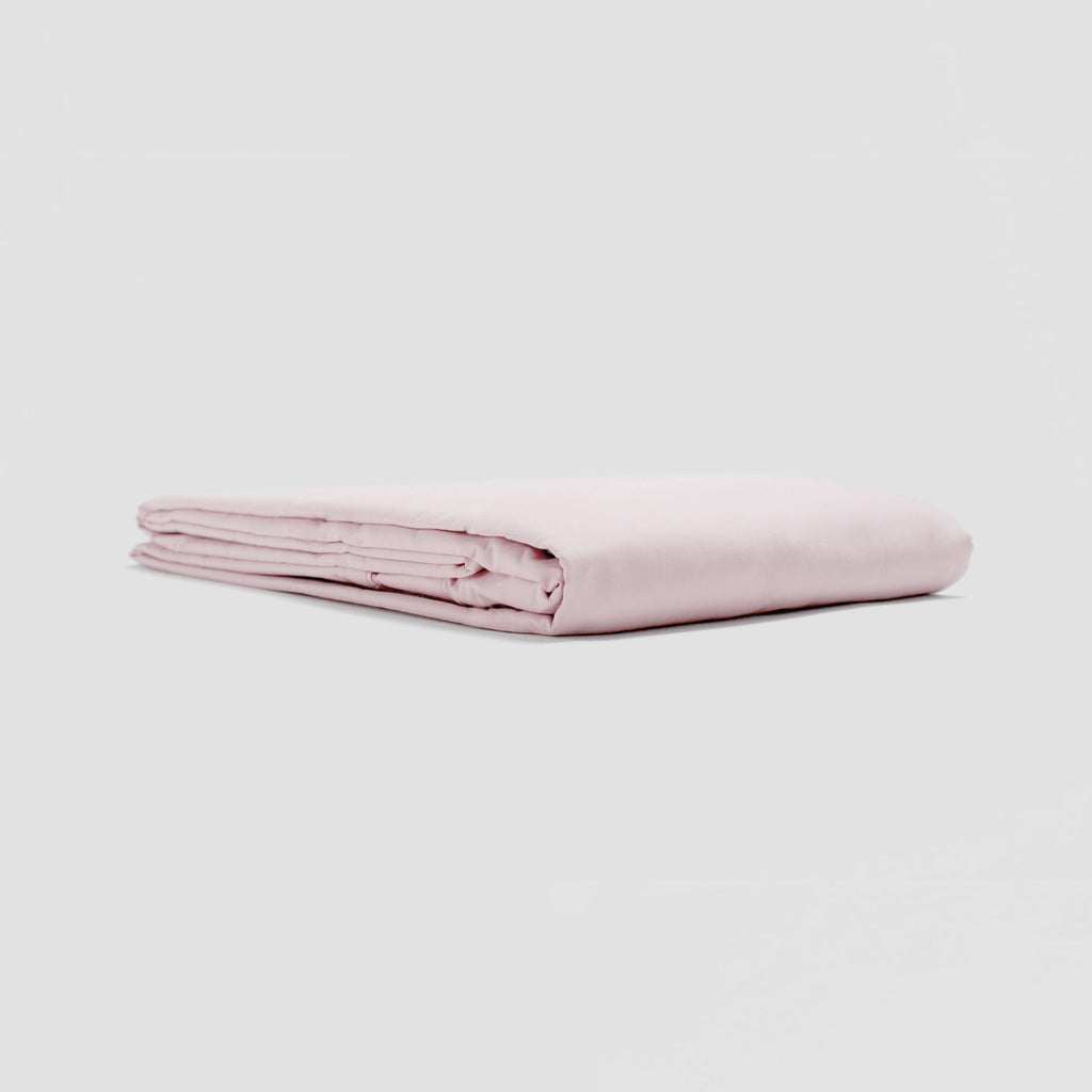 Folded pink fabric on a light gray background
