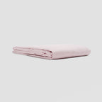 Folded pink fabric on a light gray background