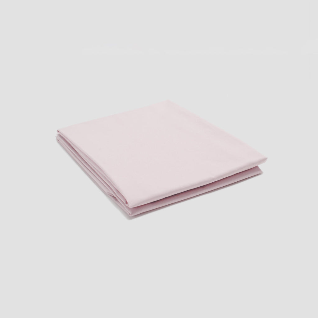 Folded pink fabric on a light gray background