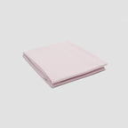 Folded pink fabric on a light gray background