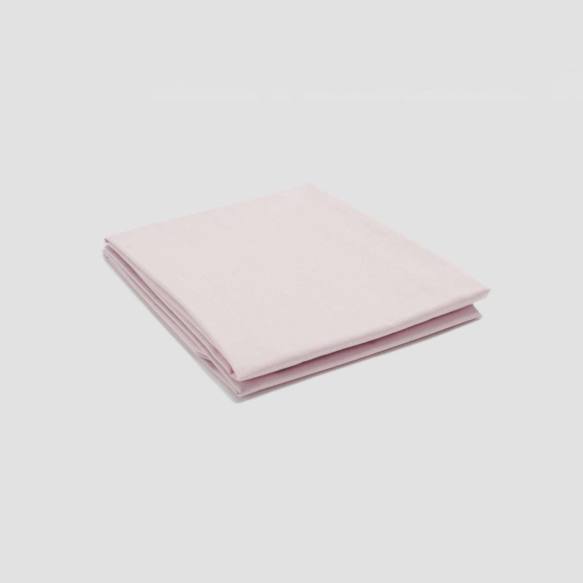 Folded pink fabric on a light gray background