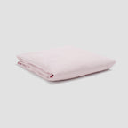 Folded pink fabric on a light gray background