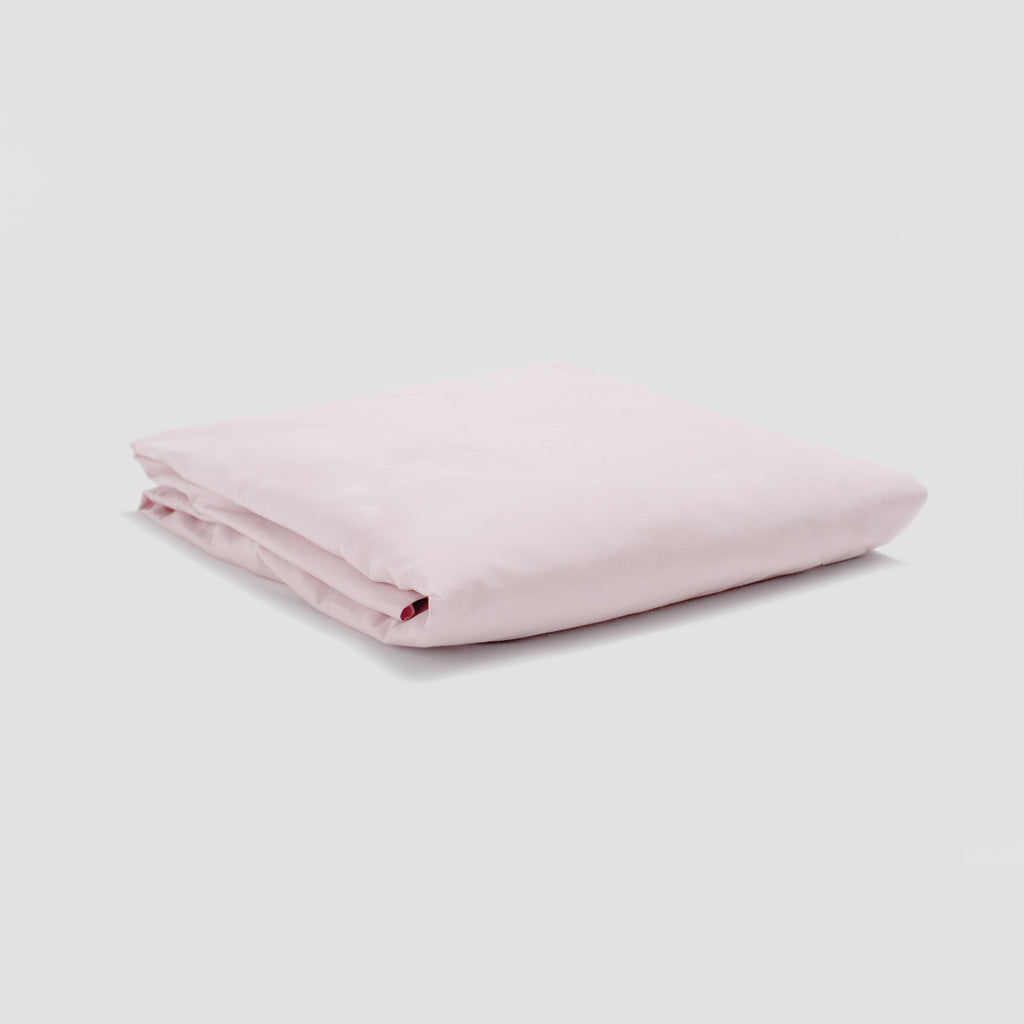 Folded pink fabric on a light gray background