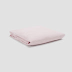 Folded pink fabric on a light gray background