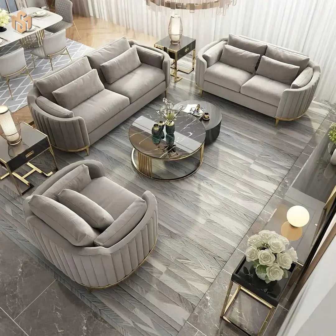 Modern living room with gray sofas, armchair, and coffee table on a marble floor.
