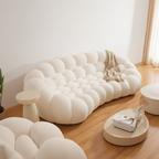 Modern white sofa with a textured surface in a minimalistic room.