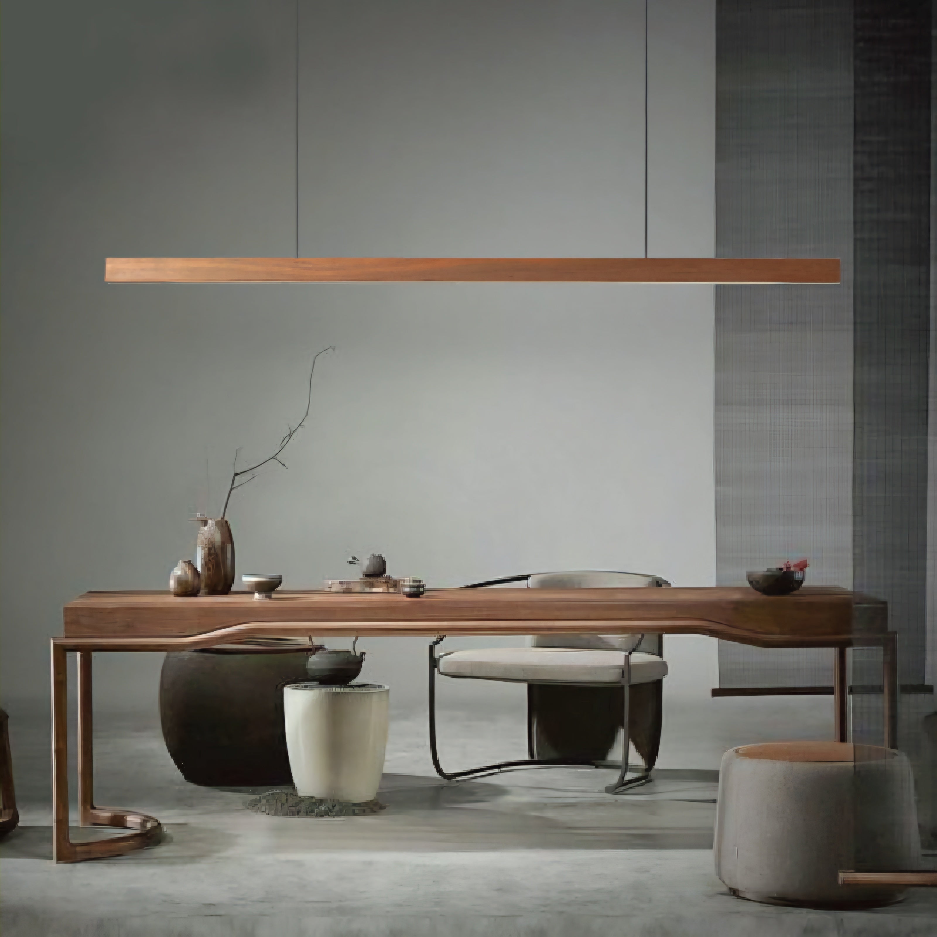 A modern wooden dining table with a long rectangular top and sculptural curved legs, styled in a minimalist dining room setting with a matching chair, pendant light, and ceramic vessels.