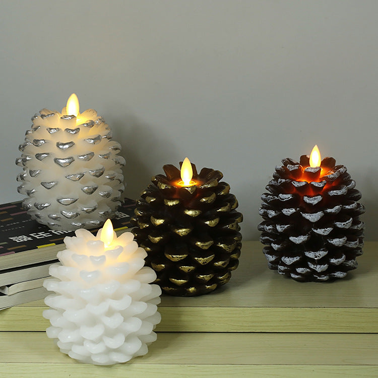 Set of four decorative candles with unique designs on a wooden surface.