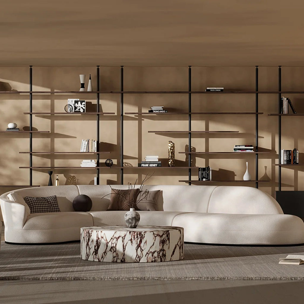 Modern living room with a white sofa, coffee table, and decorative shelves.