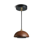 Pendant light with brown shade and black fixture on a white background