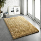 Beige rug on a gray floor with a white wall and sliding glass door in the background