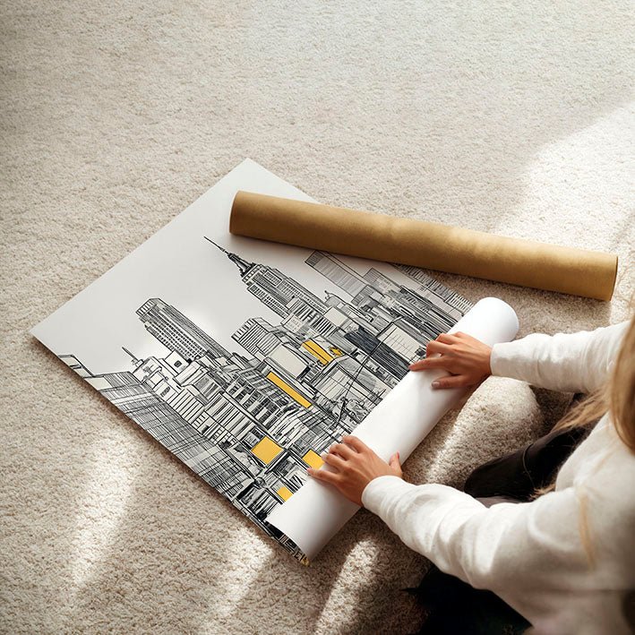 Person unrolling a large cityscape poster on a carpeted floor