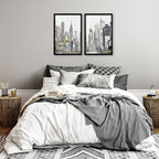 Bedroom with gray and white bedding, cityscape wall art, and wicker nightstands.