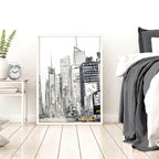 Cityscape artwork on a wall in a bedroom with a bed and nightstand.
