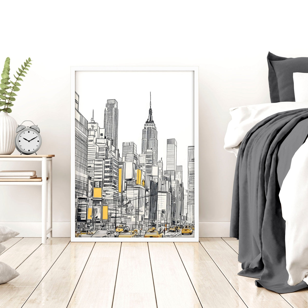 Cityscape artwork in a white frame on a wall above a bed with gray bedding.