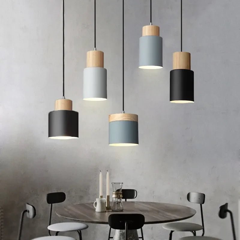 Modern pendant lights hanging above a dining table with a neutral background