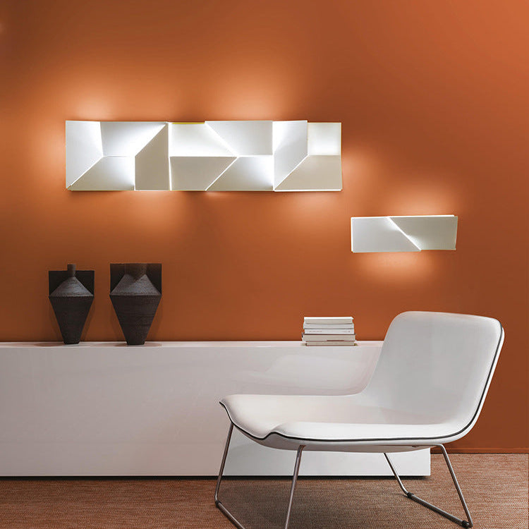 Modern white chair in a room with orange walls and decorative wall art.