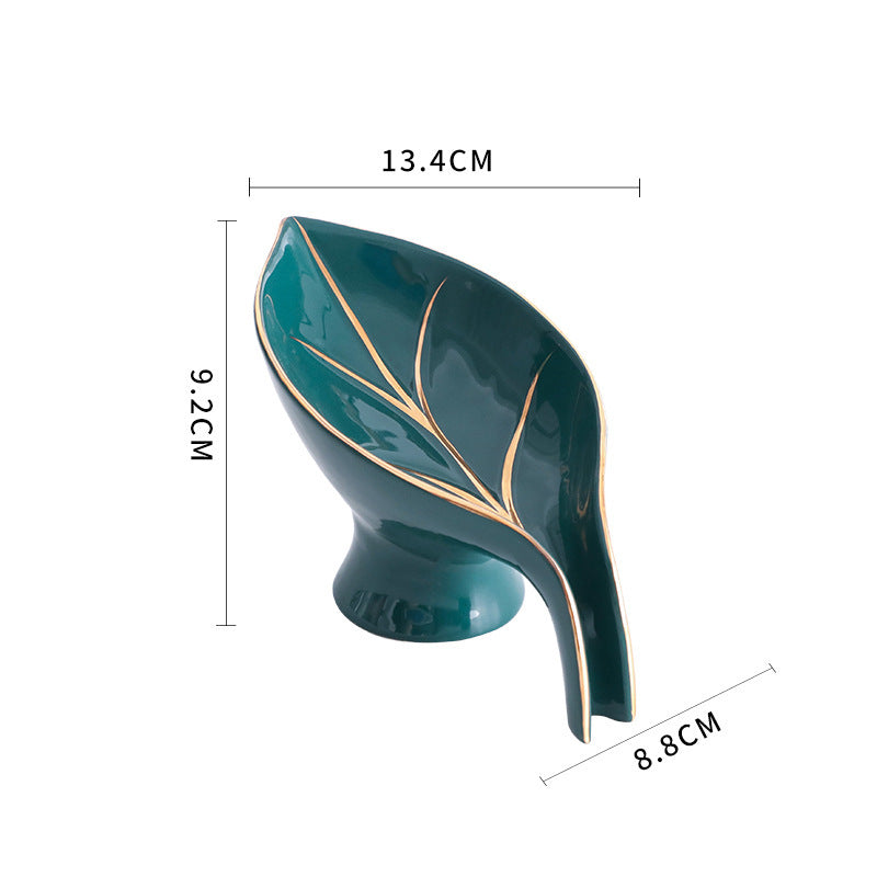 Green leaf-shaped object with measurements on a white background