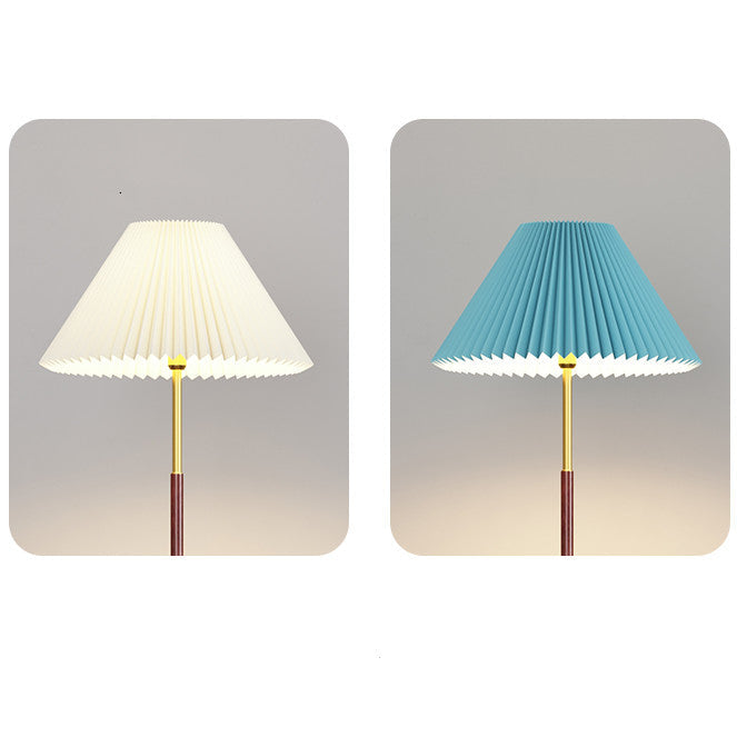 Two lamps with pleated lampshades, one white and one blue, on a gradient gray background.