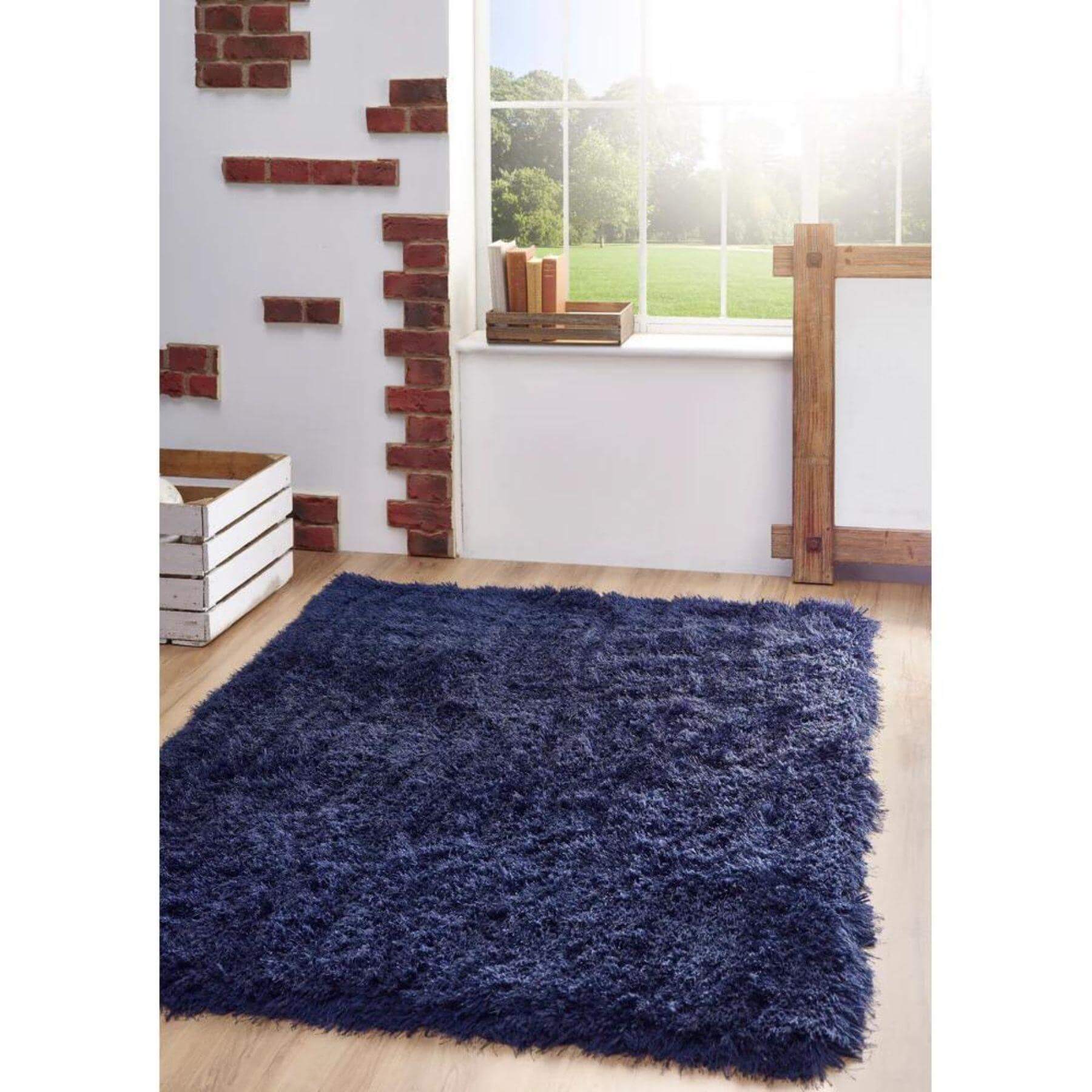 Blue shaggy rug on a wooden floor with a window and decorative elements in the background