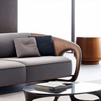 Modern gray sofa with wooden armrests in a minimalistic living room.