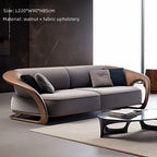 Modern gray sofa with wooden armrests in a minimalistic living room setting.