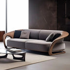 Modern gray sofa with wooden armrests in a minimalistic living room.