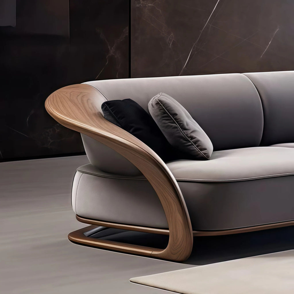 Gray sofa with wooden armrests and dark cushions against a dark wall.
