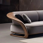 Gray sofa with wooden armrests and dark cushions against a dark wall.