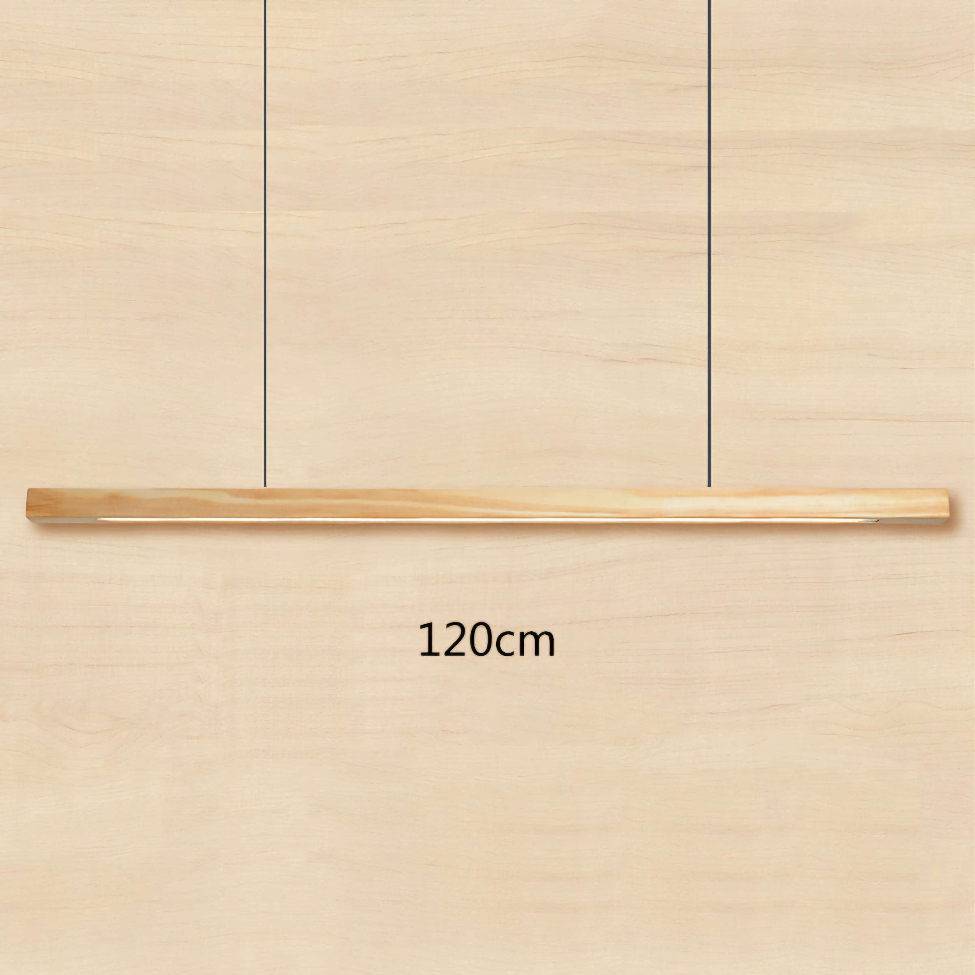 A minimalist linear pendant light in a light natural wood finish, suspended by two thin black cables. The image features a dimension overlay indicating '120cm' length, set against a matching light wood grain background.