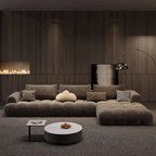Modern living room with a large brown sofa, coffee table, and decorative items.