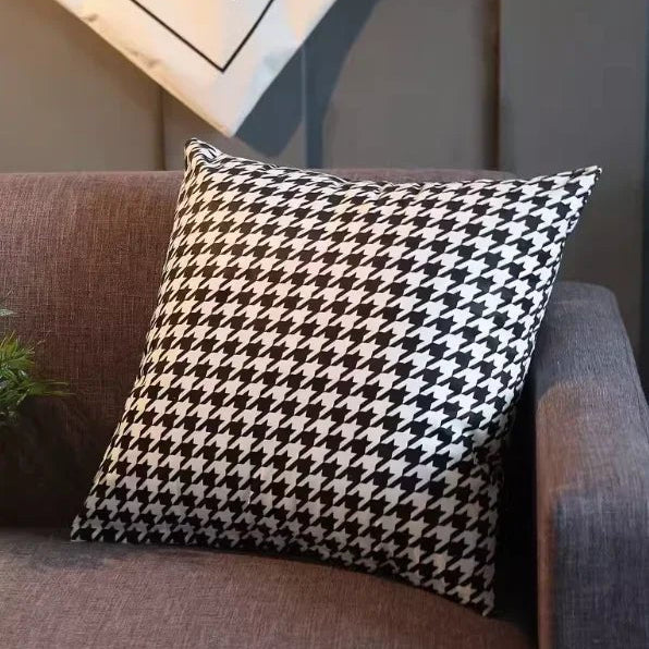 An L-shaped brown velvet sofa with multiple cushions, placed in a modern living room setting with a contemporary fireplace and decorative pillows.