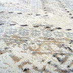 Close-up of a textured white surface with black specks