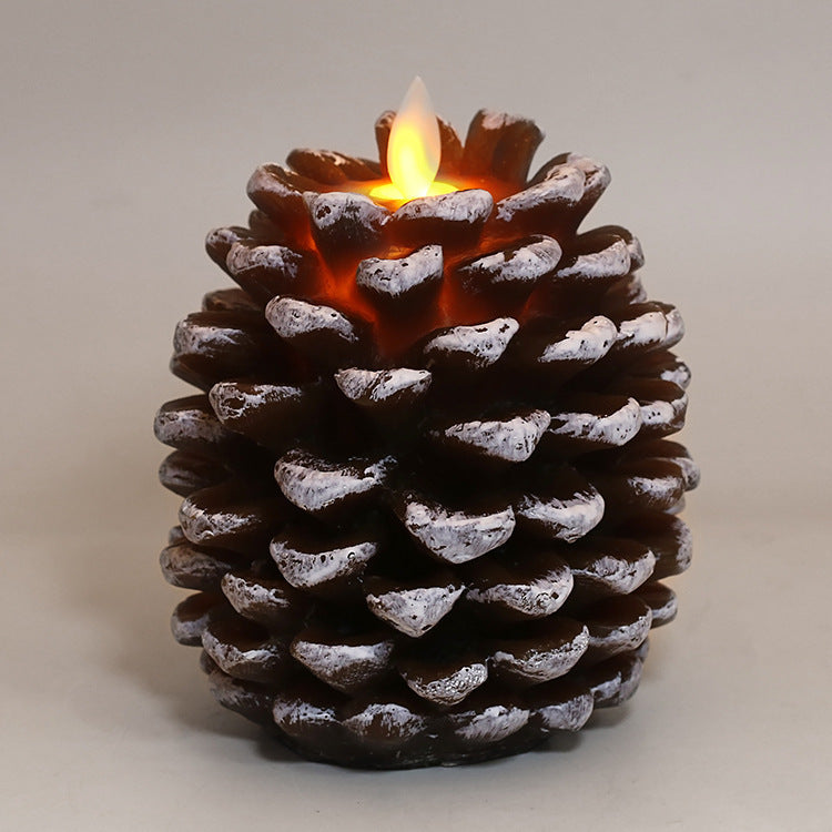 Flickering candle inside a pine cone on a neutral background