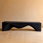 Modern black bench on a beige floor with a beige wall background