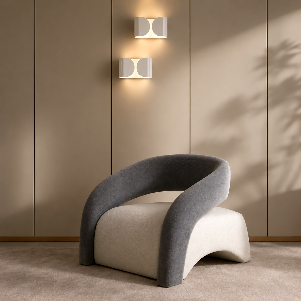 Modern chair with curved design in a minimalistic room with wall lights.