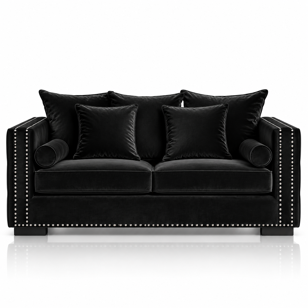 A black velvet loveseat sofa with matching throw pillows, featuring silver nailhead trim along the armrests and front edge, set against a clean white background with a subtle reflection below.