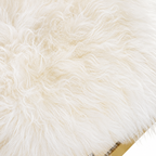 Detailed close-up of soft ivory faux fur fibers on a luxury ottoman